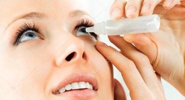 woman instill eye drop